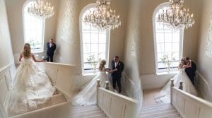 Father greets Bride on the stairs ahead of aisle walk