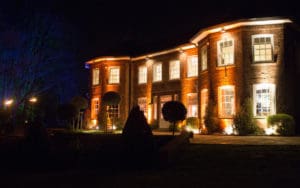 Delamere Manor at night lit up