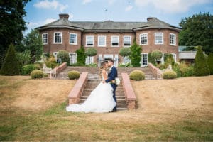 Couple kissing infront of Delamere Manor