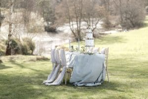 wedding table with cake outside by the river