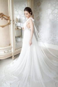 Bride appreciating her white wedding dress