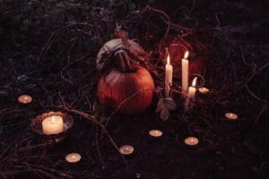 pumpkin in a field with candles
