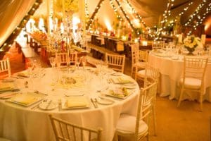 Fairy lights above wedding tables