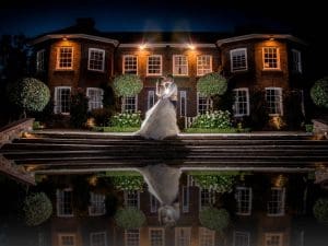 bride and groom outside delamere manor at night