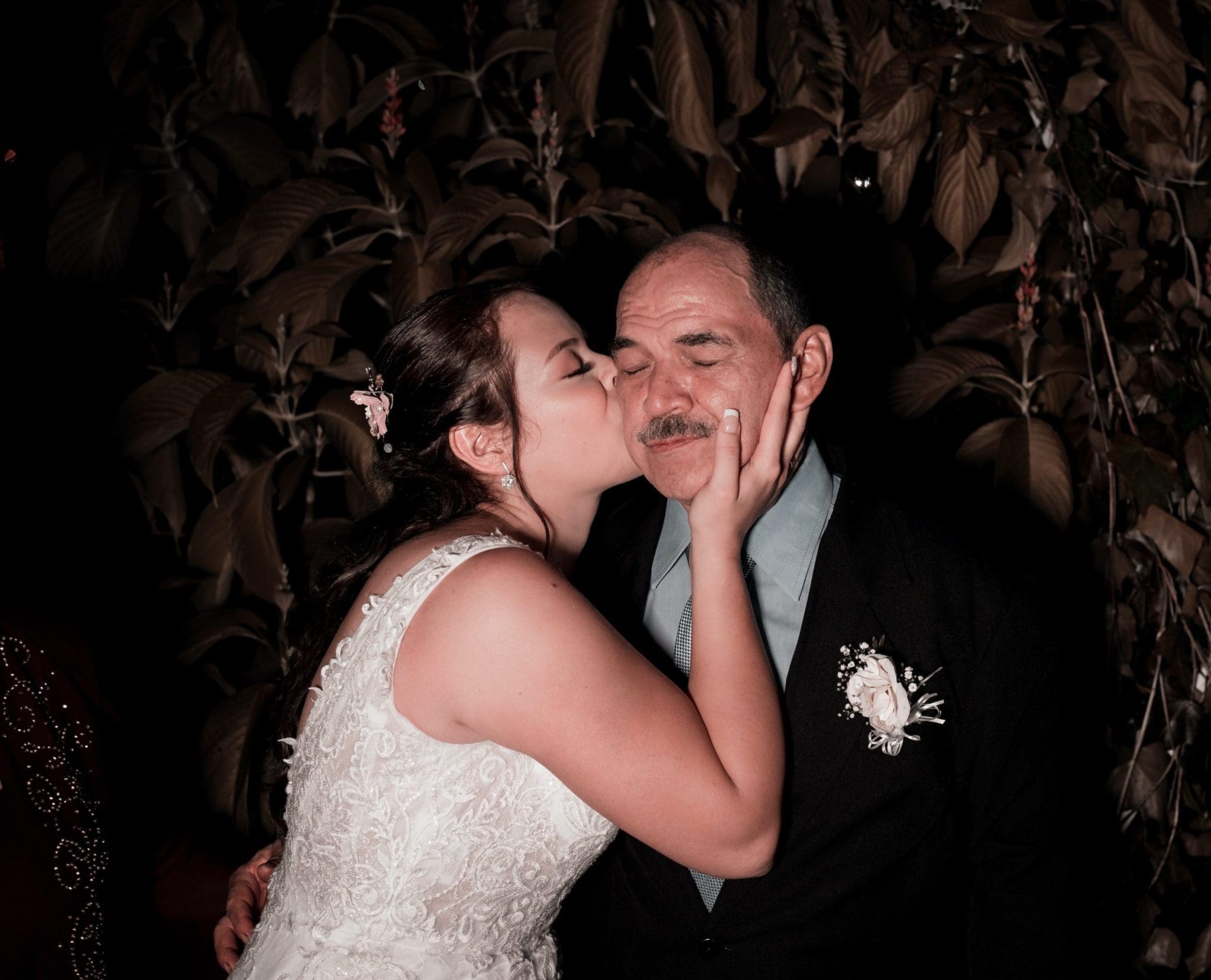 Father and daughter wedding kiss