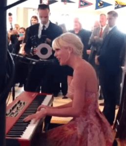Tayloe Swift singing at a wedding