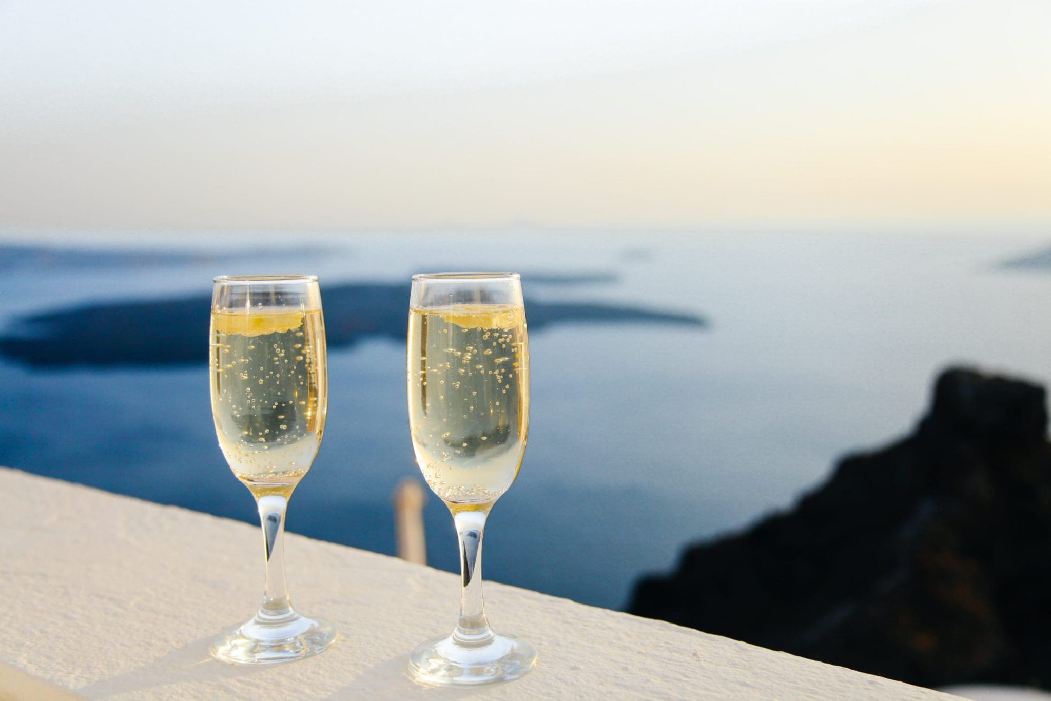 Two glasses of champagne over a sea view