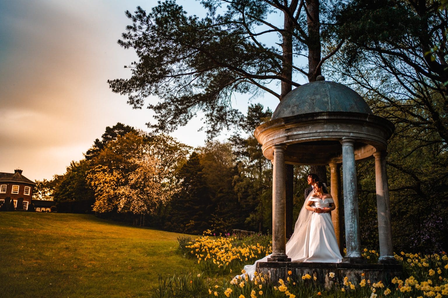 Bride & Groom standing at the folly Delamere Manor